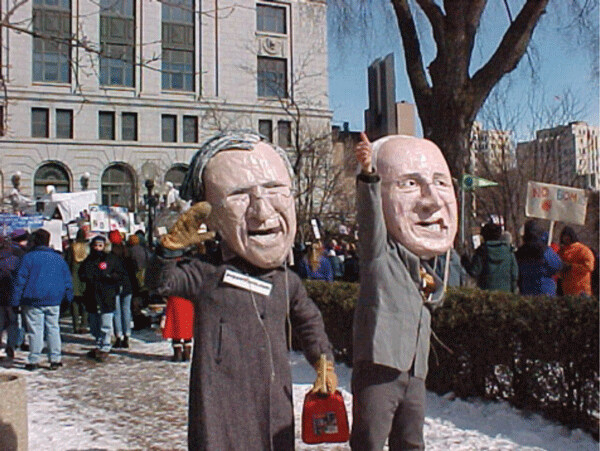 Effigies of two prime examples of unindicted War Criminals, both of whom were draft-dodgers during the Vietnam War. President George W. Bush and Vice President Dick Cheney were typical of many other Bush administration “Chicken Hawk” politicians who were behind the disastrous and illegal invasion of Iraq (Photographed at Duluth, Minnesota’s Anti-War Rally – March 8, 2003)